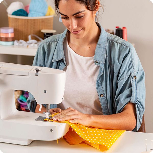 person sewing with a sewing machine